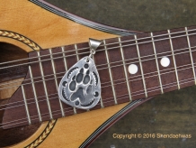 Fine silver wolf paw in guitar pick shape by Shendaehwas. Fine silver wolf paw in guitar pick shape by Shendaehwas.
